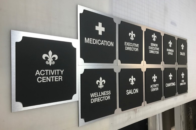 ADA office signs for activity center, wellness director, medication and executive rooms