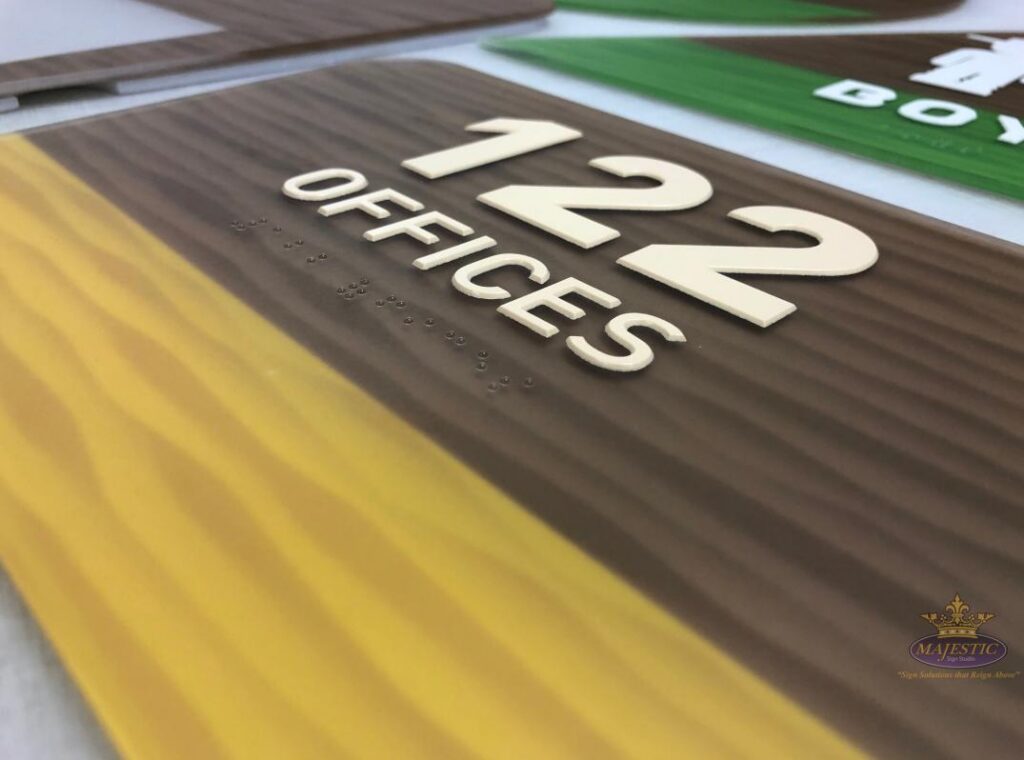 Room 122 offices sign with raised numbers, tactile lettering, and braille