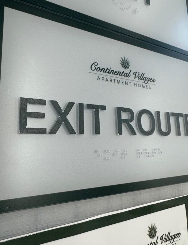 Continental Villages Apartment Homes exit route sign with raised lettering and braille