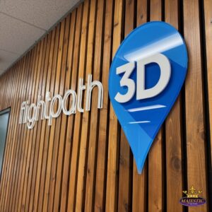 Close-up of FlightPath3D dimensional lobby logo sign installed on a wood slat wall in its Irvine, CA office