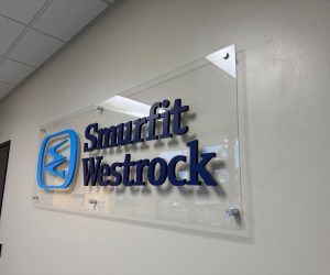 Acrylic wall sign with blue 3D letters mounted on standoff hardware in Corona, CA.