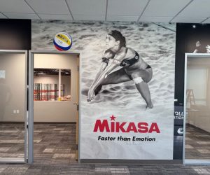 Large wall mural with volleyball player and ball graphics in Corona, CA.