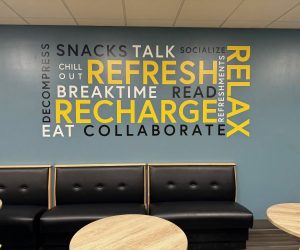 Vinyl wall decal with motivational words above black seating in Corona, CA.